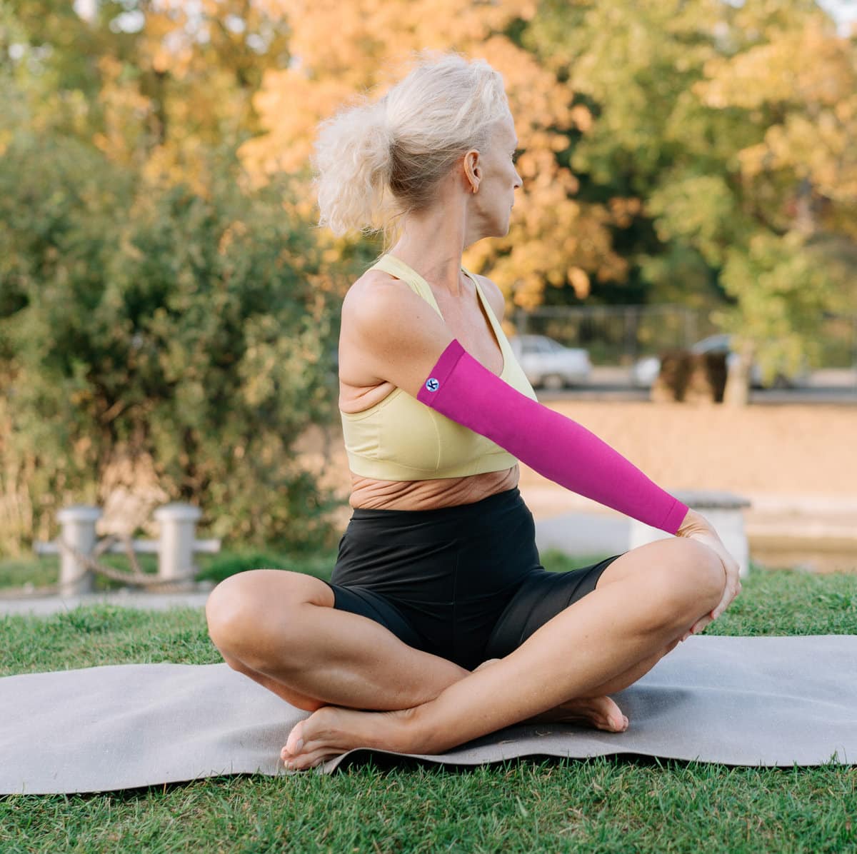 A woman doing her yoga session with Kinship arm sleeve
